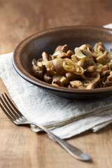 Onion with mushrooms. Rustic wooden background. 