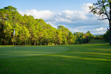 Beautiful golf course in a sunny day. Background evening golf course has sunlight shining down.