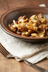 Onion with mushrooms. Rustic wooden background.	