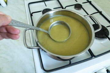 ladle scooping creamy leek soup