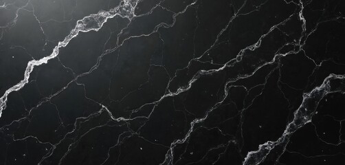 Black marble stone texture background. White veins pattern across dark natural stone slab. Luxury material for interior design. Elegant surface for kitchen bathroom decor, modern house. Dark
