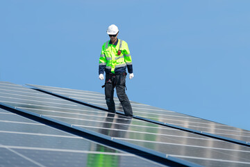 Engineer man check installation solar cell on the roof of factory , Sustainable energy industry concept, Renewable energy solution for climate change
