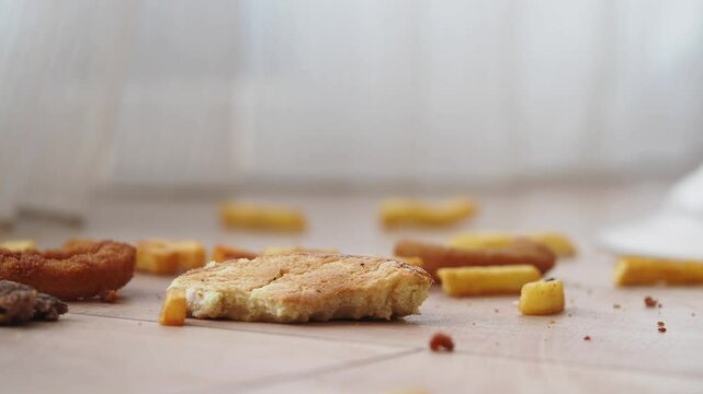 Crumbled snacks lie on the floor, creating a messy and playful setting