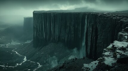 Majestic Waterfall Cascading from Rugged Cliff in Misty Landscape