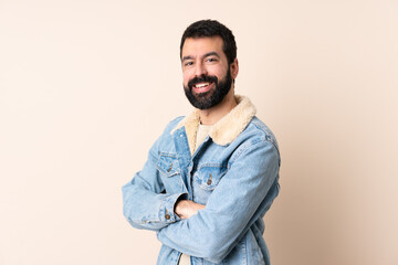 Caucasian man with beard over isolated background with arms crossed and looking forward