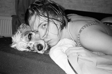Woman resting her head on a spaniel in a quiet black and white moment