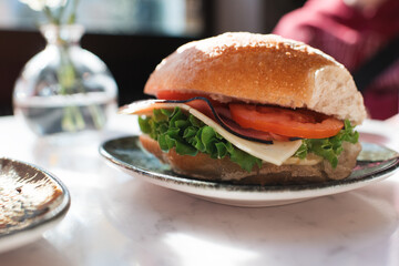 freshly made sandwhich with salad on a table in a cafe