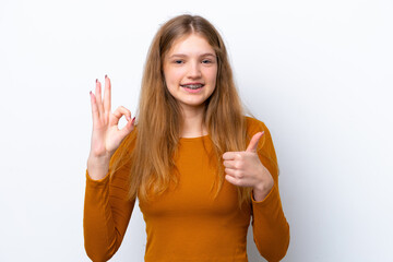 Teenager Russian girl isolated on white background showing ok sign and thumb up gesture