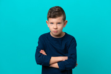 Little kid boy isolated on blue background feeling upset