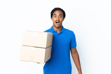 Delivery African American man with braids isolated on white background with surprise facial...