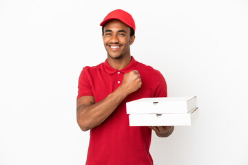 African American pizza delivery man picking up pizza boxes over isolated white wall celebrating a...