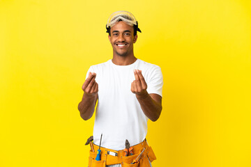 African American electrician man over isolated yellow wall making money gesture