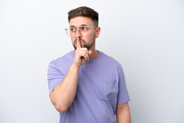 Young caucasian man isolated on white background showing a sign of silence gesture putting finger...