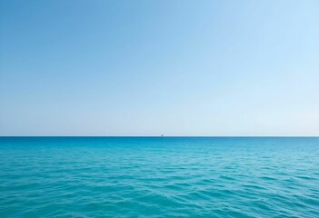 Obraz premium Vast expanse of blue ocean under a bright sky, with a tiny boat visible far away on the calm horizon.