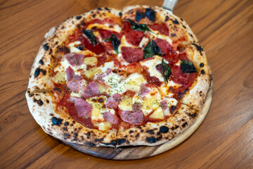 Close up of Pepperoni and Hawaiian Pizza on the table.