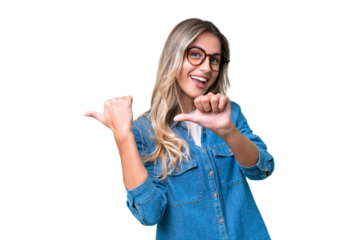 Young Uruguayan woman over isolated background pointing to the side to present a product