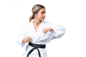 Young Uruguayan woman over isolated background doing karate