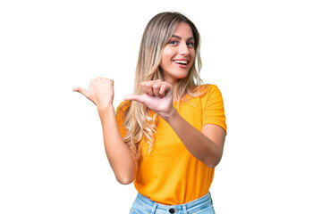 Young Uruguayan woman over isolated background pointing to the side to present a product