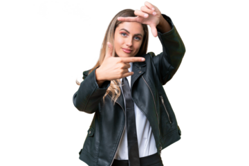 Business pretty Uruguayan woman wearing a biker jacket over isolated background focusing face. Framing symbol