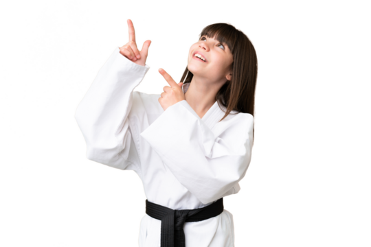 Little Caucasian girl doing karate over isolated background pointing with the index finger a great idea