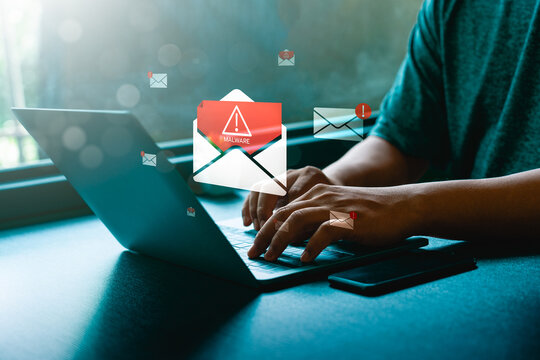 Cybersecurity threat concept showing a man using laptop with floating email icons containing malware warnings and danger signs, symbolizing phishing scam, virus attack, and online data security risk
