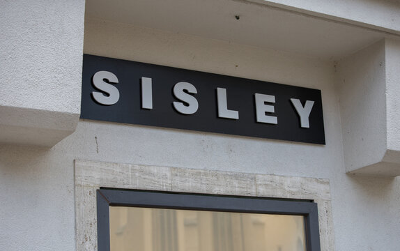 Sisley store sign on building wall with modern black and white design