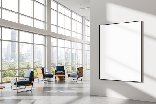 Blank poster mockup on clean white wall in bright modern office interior with large windows and cityscape view in background for advertising concept. 3D Rendering