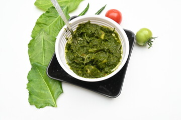 Indian Spinach and Potato Curry. Indian vegetable curry with spinach and potato. A dry dish made from fried potatoes and spinach in Indian style. 
