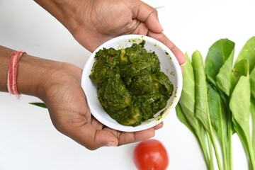 Indian Spinach and Potato Curry. Indian vegetable curry with spinach and potato. A dry dish made from fried potatoes and spinach in Indian style. 
