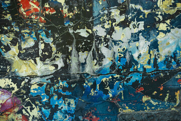 Abstraction of crumbling graffiti on a city street wall. Colorful abstract background. Old,...