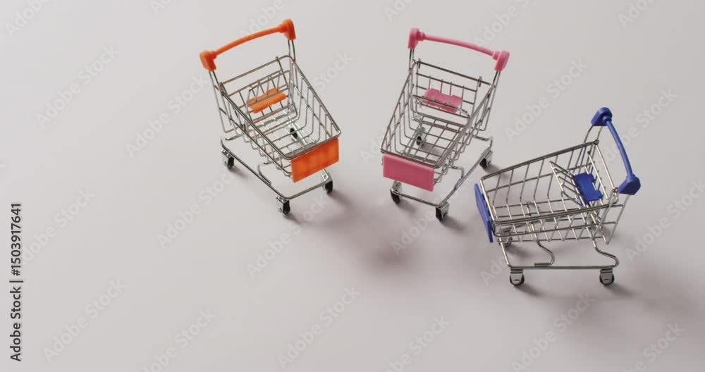 Poster high angle view of three empty shopping trollies on white background with copy space