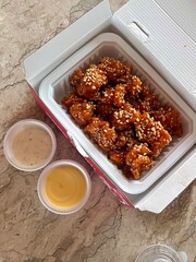Crispy Korean fried chicken, perfectly glazed with a sweet and spicy sauce. Ideal for food photography and menus, showcasing the irresistible crunch and flavor of this beloved dish.