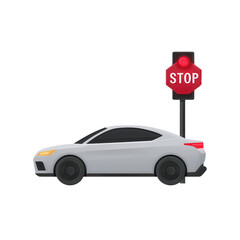 A modern gray car stopped beside a red stop sign.