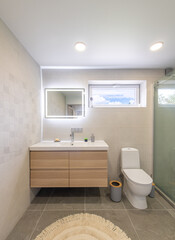 Modern Home Bathroom Interior With Wooden Vanity and Spacious Glass-Enclosed Shower