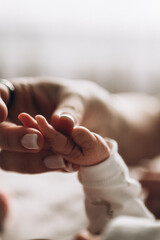 Newborn baby hand in hand