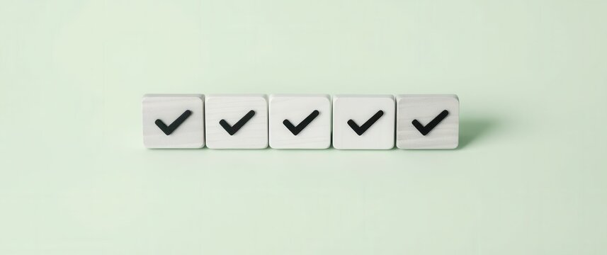 Five wooden blocks aligned in a row, each marked with a bold black checkmark, signifying approval.