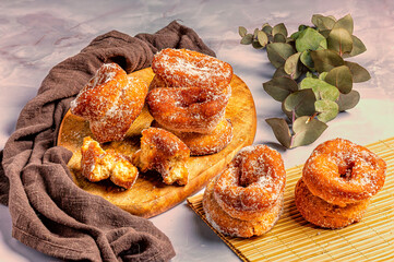 Homemade sugar donuts on wooden board