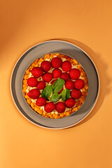 Fresh dessert with strawberries, basil leaves, and crunchy cereal on top, perfect for healthy eating breakfast with fiber