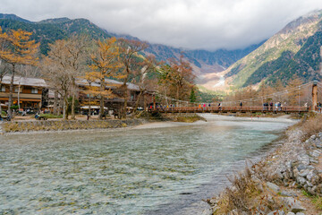 landscape view of japan alps mountain with natural forest, blue river on autumn season at Kappa bashi bridge kamikochi Nagano.