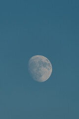 Almost full moon over a blue sky.