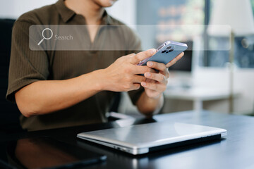 Searching Browsing Internet Data Information Networking Concept with blank search bar. man working with mobile phone and laptop computer