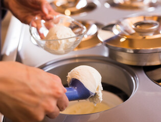 Ball of vanilla ice cream in ice cream razor in cafe