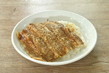 slice grilled salt fat pork with teriyaki sauce dressing white sesame topping Japanese rice on plate