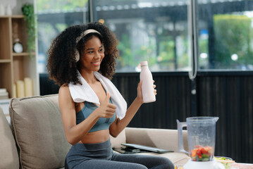 Woman enjoys a fresh salad with fruits and juice, embodying wellness, nutrition, and vitality