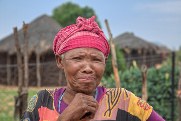 village old african woman single poverty , wearing traditional patterns africa dress she has deep...