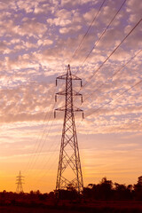 Electric pole on sunset background. Sunset over power lines. Clean energy High voltage electric tower . Power tower