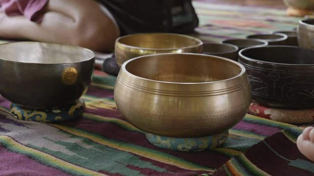 Tebet singing bowls stand on the floor before the start of the bowls ceremony in a gazebo on Bali Island