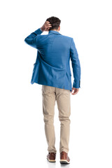 Fototapeta premium confused young man scratching head and thinking while walking