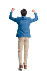 enthusiastic casual man holding fists above head and celebrating