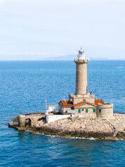 A majestic Porer Lighthouse stands proudly on a rocky island off Istria’s coast, with its...